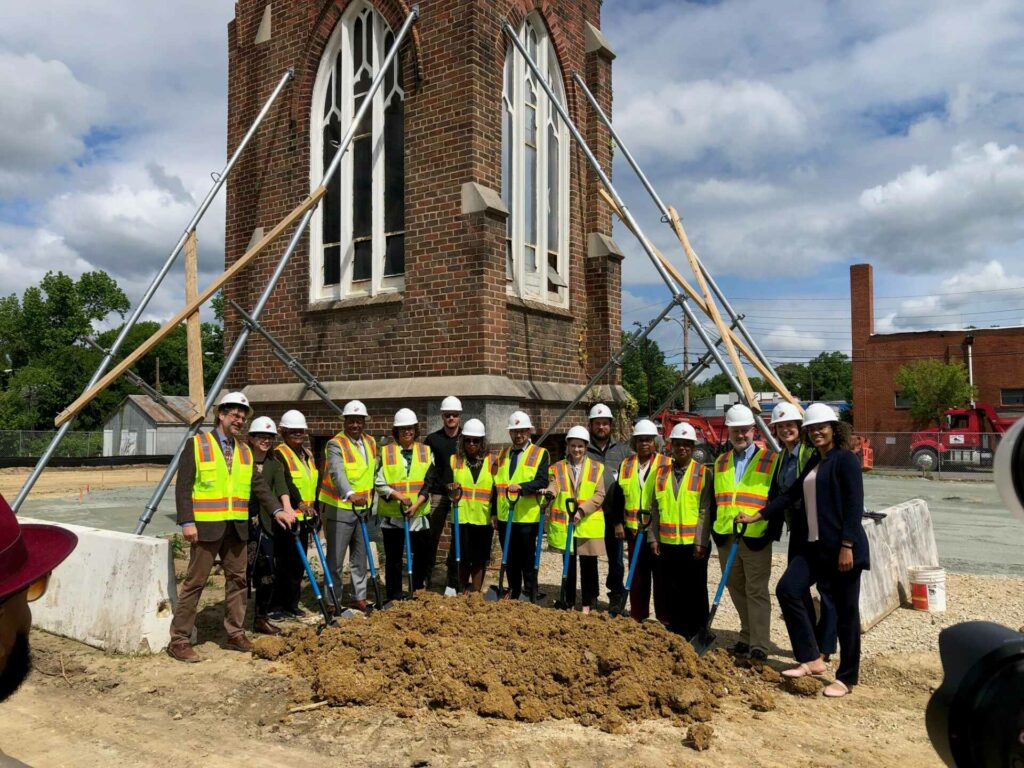 a crew celebrating groundbreaking for brookland apartments