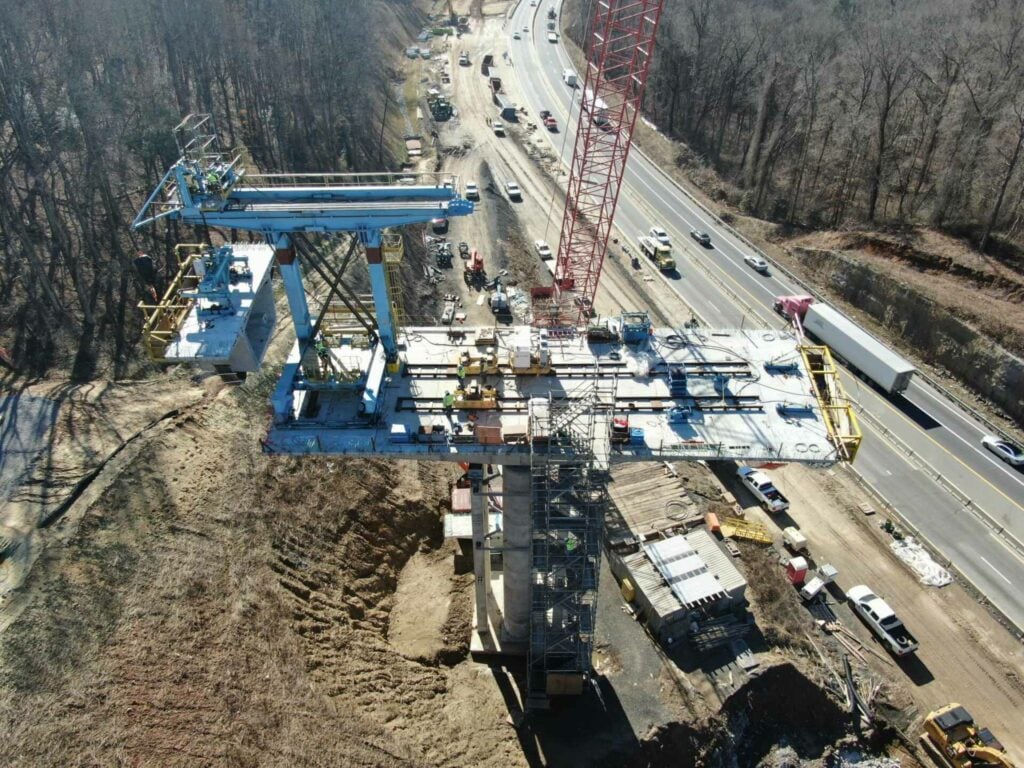 a construction site with cranes and cars