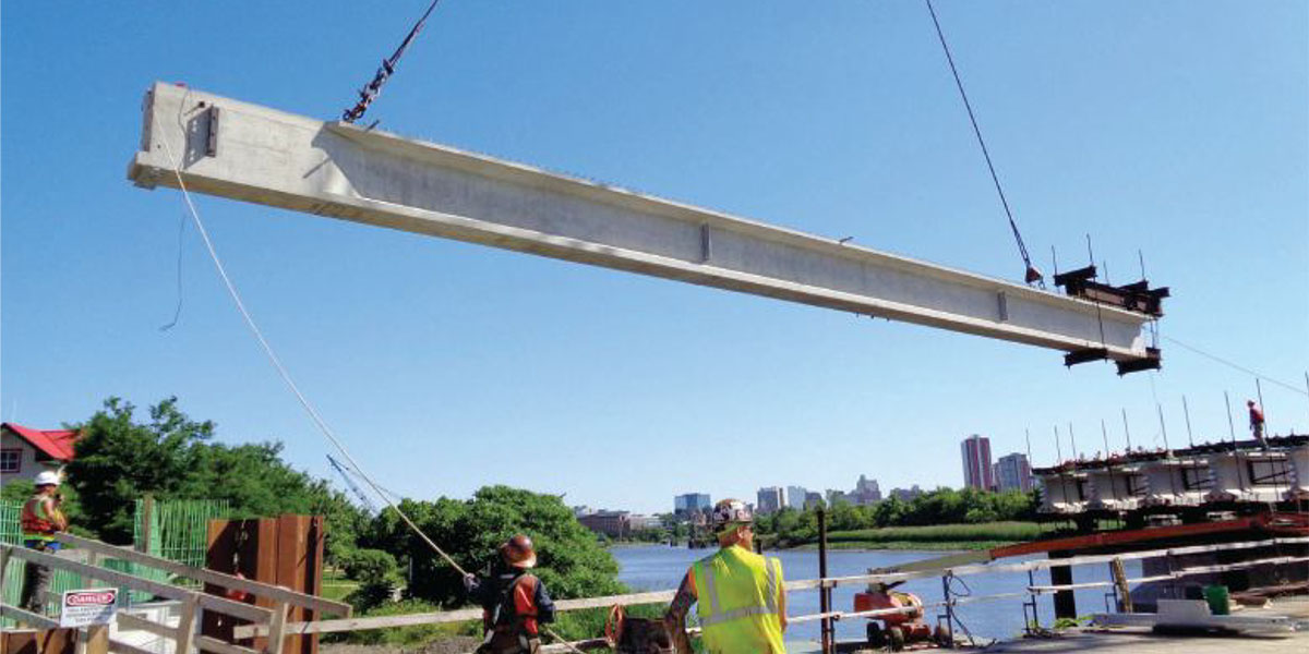 Erection of an end girder segment in span 1 from the working platform on the Christina River Bridge.