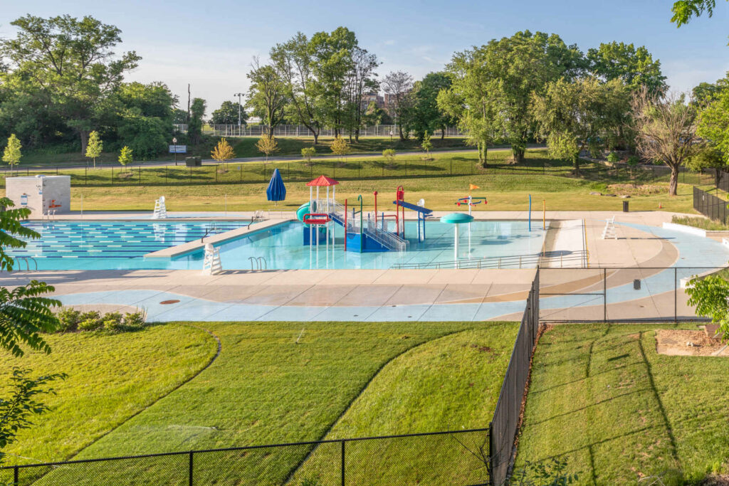 an aerial view of a swimming pool in a park.