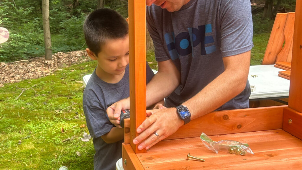 Francisco helping to assemble the playset