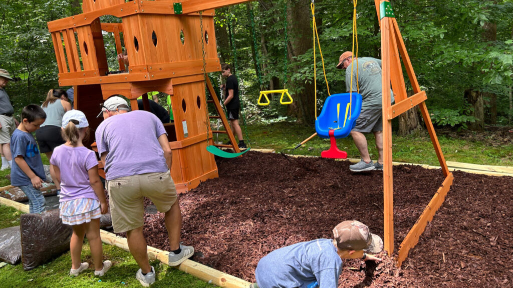 Spreading mulch around the playset